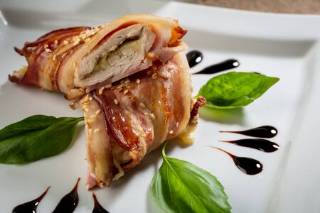 meat with bacon dish on white plateの写真素材