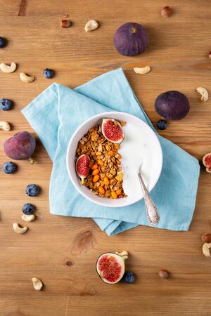 Granola  withfigs and yogurt on wooden tableの写真素材