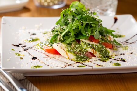Fresh caprese salad with pesto on plate, food close-upの写真素材