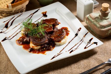 Braised meat  dish on white plateの写真素材