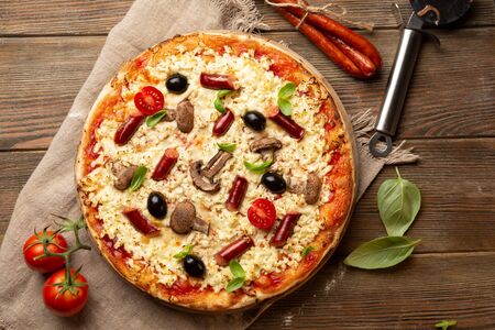 Whole pizza with mushrooms top viewの写真素材
