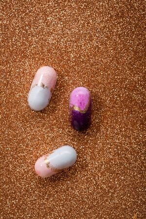 Three chocolate bonbons on shining background top viewの写真素材