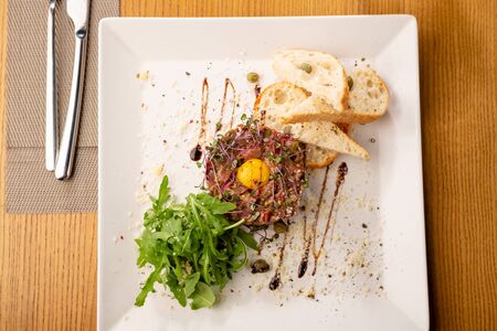Tartar with eggs with toasted breadの写真素材