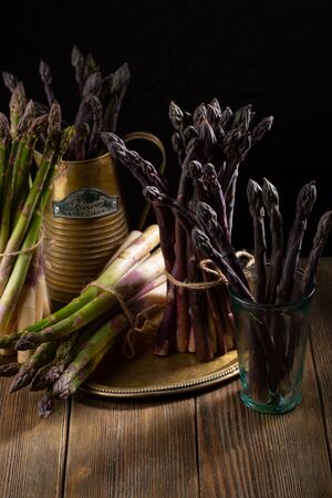 Still life with violet and green asparagusの写真素材