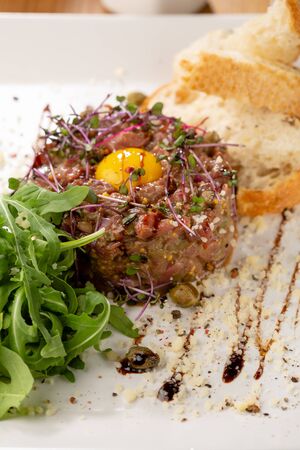 Tartar with egg and arugula close-upの写真素材