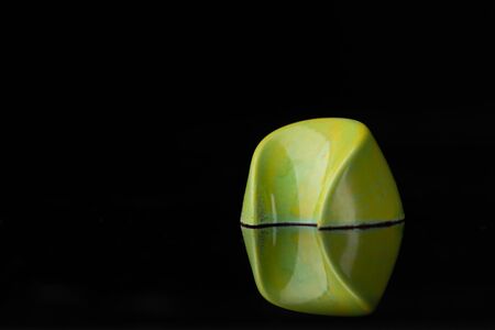 Beautiful modern green chocolate candy on blackの写真素材