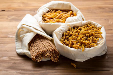 Whole grain different pasta in white eco cotton bagの写真素材