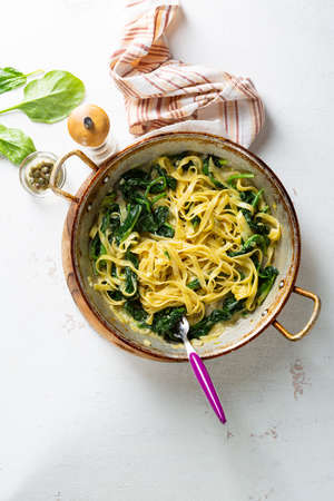 Pasta with spinach in pan top viewの写真素材