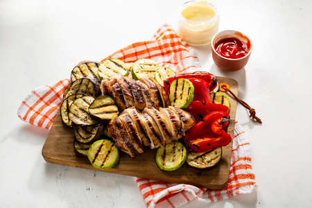 Tasty bbq meat and vegetables with sauces, grilled foodの写真素材