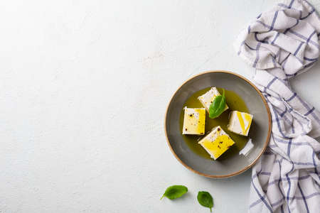 Feta with olive oil and spice in bowlの写真素材