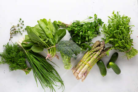 Green organic vegetables and herbs top viewの写真素材