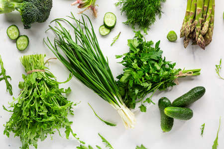 Green vegetable produce on white surface top viewの写真素材