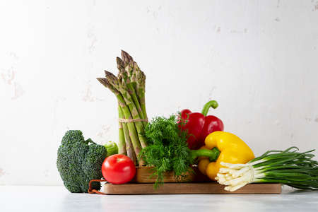 Still life with organic vegetables on white table