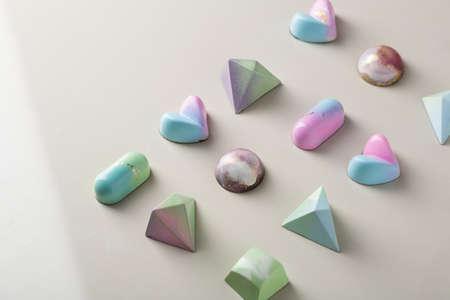 Set of chocolate candies on light stone surface