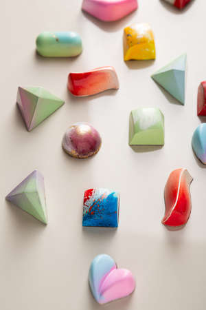 Mixed chocolate candy on light stone surfaceの写真素材