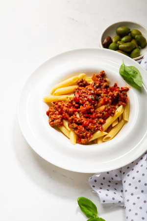 Close up of Tasty italian penne pasta with bolognese sauceの写真素材