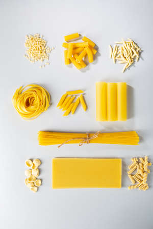 Uncooked pasta top view on gray backgroundの写真素材