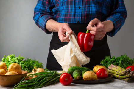 Men after shopping , food coming out white cotton bag. Conscious consumptionの写真素材