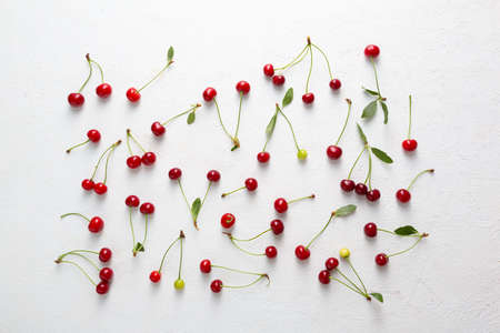Organic summer cherry on white surface, food patternの写真素材