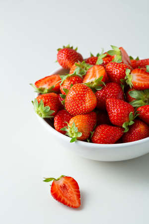 Fresh summer strawberry in white bowlの写真素材