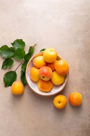 Overhead view of fresh yellow apricot on stone tableの写真素材
