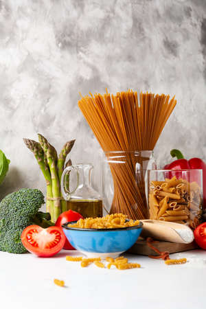 Uncooked whole grain pasta and ingredientsの写真素材