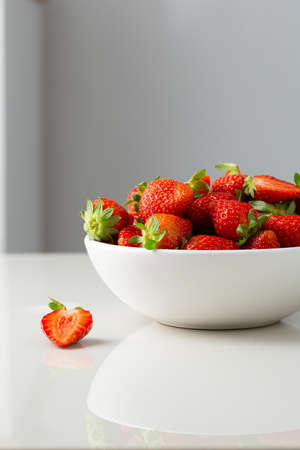 Close up of bowl of strawberry o white tableの写真素材