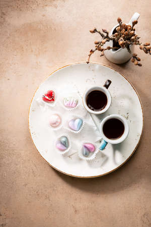 Overhead view of two cups of coffee and candiesの写真素材