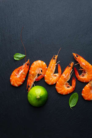 Overhead view of Cooked tiger prawns with limeの写真素材