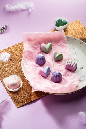Sweet modern candies on white plateの写真素材