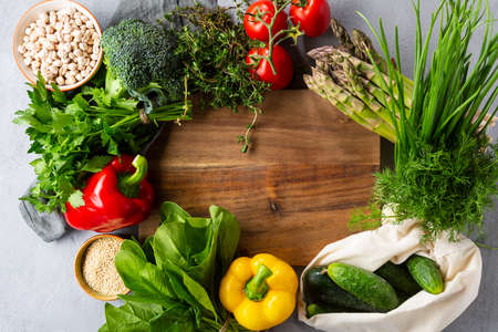Wooden kitchen board and vegetables. Cooking  vegan food conceptの写真素材