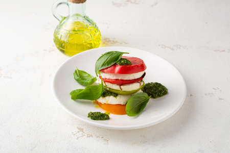 Tomato and cheese summer salad, caprese with pestoの写真素材