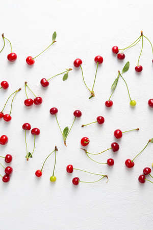 Overhead view of Summer cherry pattern on white surfaceの写真素材