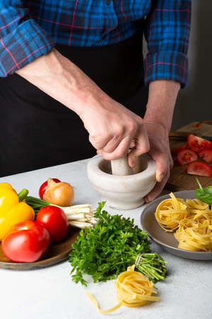 Making sauce for pasta, fresh ingredients on white tableの写真素材