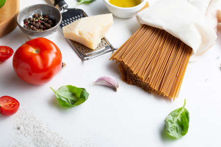 Whole grain spaghetti with cheese on white tableの写真素材