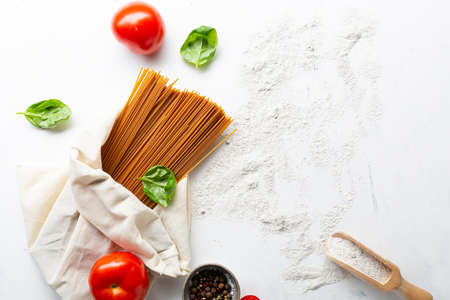Bunch of wholegrain spaghetti in white eco shopping bagの写真素材
