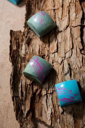 Close up of modern chocolate candies on wood