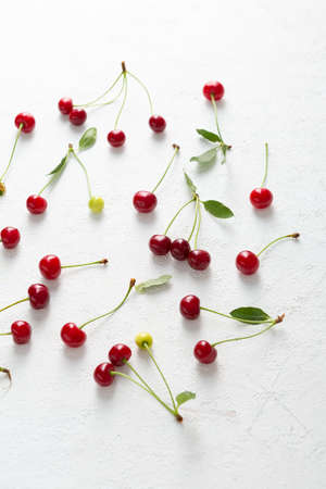 Overhead view of Summer cherry on white surfaceの写真素材