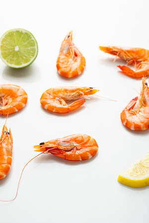 Shrimps with lime on light surfaceの写真素材