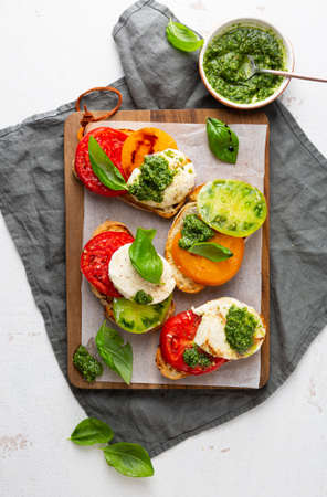 Tomato and cheese toast with pesto sauceの写真素材