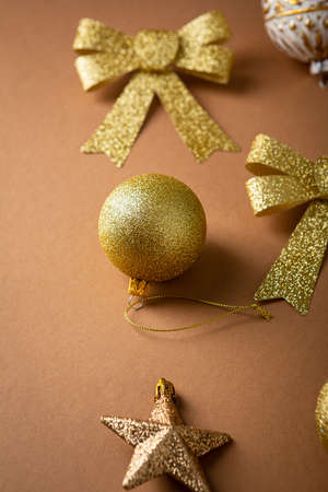 golden Christmas decorations on brown surface, holiday conceptの写真素材