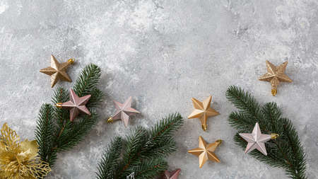 Silver and golden Christmas decorations and green branchesの写真素材