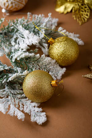 Close up of golden Christmas baubles and snowy branchの写真素材