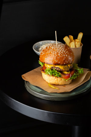 fresh tasty burger on black table  and friesの写真素材