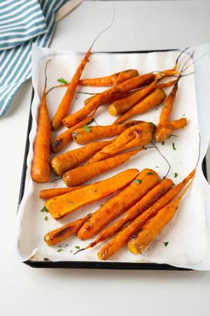 Roast carrots on baking trayの写真素材