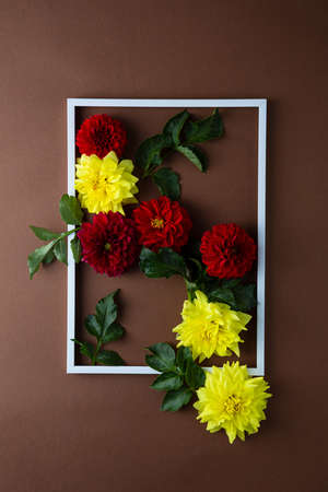 Summer flowers and white frame on brown surfaceの写真素材