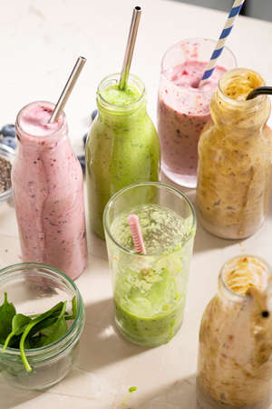 Various healthy summer smoothie on light surfaceの写真素材