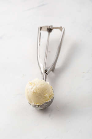 Ice cream scoop on spoon close upの写真素材