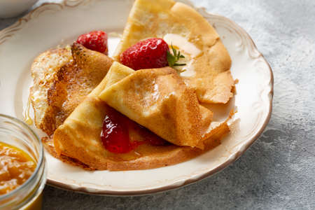 Breakfast french crepes with strawberry jamの写真素材
