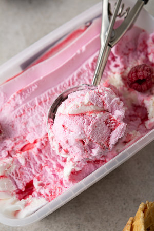 Overhead view of pink ice cream and scoop spoonの写真素材